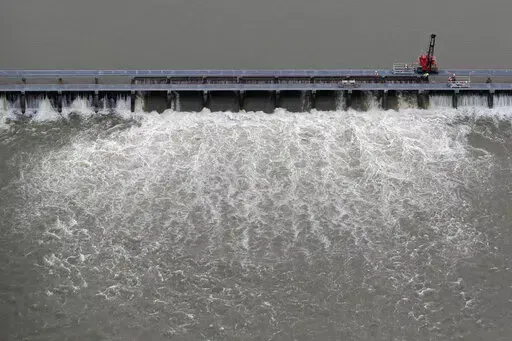 Workers open bays of the Bonnet Carre Spillway to divert rising water from the Mississippi River to Lake Pontchartrain, upriver from New Orleans, in Norco, La., May 10, 2019. A federal judge ruled Wednesday, Jan. 18, 2023, that the U.S. Army Corps of Engineers must consult with federal fisheries experts on the effects of opening the spillway that helped prevented Mississippi River flooding in New Orleans, but caused damage to coastal Mississippi marine life and tourism in 2019. (AP Photo/Gerald 