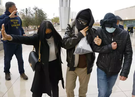 Alexander Smirnov, second from right, leaves the courthouse on Feb. 20, 2024, in Las Vegas. Smirnov, a former FBI informant charged with lying about a multimillion-dollar bribery scheme involving President Joe Biden’s family, will appear in a California federal court on Monday, Feb. 26, as a judge considers whether he must remain behind bars while he awaits trial. Special counsel David Weiss’ office is pressing Judge Otis Wright II to keep Smirnov in jail, arguing the man who claims to have 