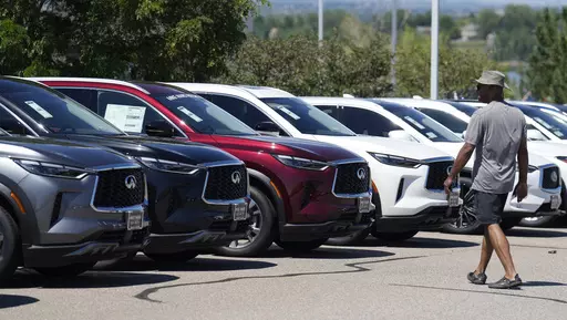 A prospective buyer surveys a row of unsold 2023 QX60 luxury sports-utility vehicles at an Infiniti dealership Sunday, Aug 27, 2023, in Highlands Ranch, Colo. (AP Photo/David Zalubowski, File)