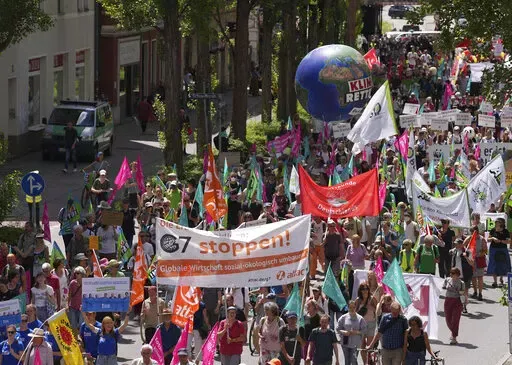 Climate activists and others hold banners and signs as they march during a demonstration ahead of a G-7 meeting in Munich, Germany, June 25, 2022. At this year's G-7 summit, Germany will push its plan for countries to join together in a ‘climate club' to tackle global warming.  (AP Photo/Matthias Schrader, File)