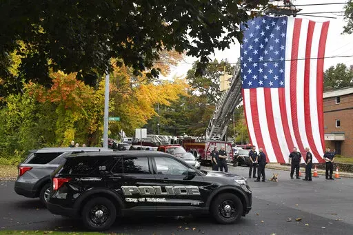 Police officers from Bristol, Conn. gather with other towns at the scene where two police officers killed, Thursday, Oct. 13, 2022, in Bristol, Conn. The deaths of two Connecticut police officers and the wounding of a third during an especially violent week for police across the U.S. fit into a grim pattern, law enforcement experts say. Even as the number of officers has dropped in the past two years, the number being targeted and killed has risen. (AP Photo/Jessica Hill, File)