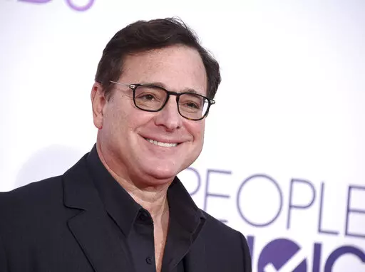 Bob Saget arrives at the People's Choice Awards at the Microsoft Theater on Wednesday, Jan. 18, 2017, in Los Angeles. Saget, a comedian and actor known for his role as a widower raising a trio of daughters in the sitcom “Full House,” has died, according to authorities in Florida, Sunday, Jan. 9, 2022. He was 65. (Photo by Jordan Strauss/Invision/AP, File)