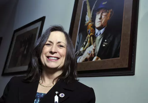 Marilynn "Lynn" Malerba stands next to a photograph of late Chief Ralph Sturges at Tribal offices in Uncasville, Conn., on March 4, 2010. Malerba, who is Native American, was nominated to be U.S. Treasurer in a historic first, Tuesday, June 21, 2022. Biden's nomination of Malerba to the federal Treasury role was announced ahead of Treasury Secretary Janet Yellen’s visit to the Rosebud Indian Reservation in South Dakota, Tuesday.  (AP Photo/Jessica Hill, File)
