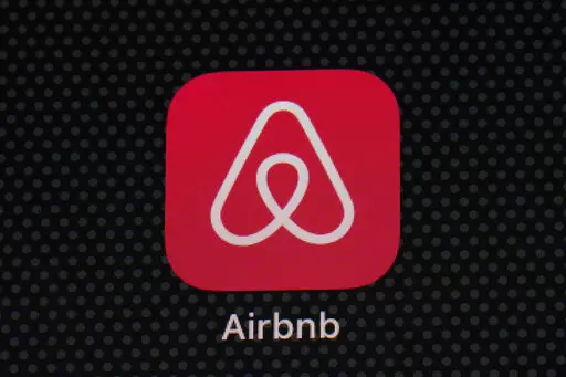 The Airbnb app icon is displayed on an iPad screen in Washington, D.C., on May 8, 2021.  NerdWallet looked at the price of 1,000 Airbnb listings and compared them to the cost of hotels. Airbnbs can be an affordable alternative to hotels, particularly for longer stays, large groups and for people who need a washer and dryer or kitchen. But beware of vacation rental cleaning fees that can make the price skyrocket, and take advantage of discounts for monthlong stays.  (AP Photo/Patrick Semansky, Fi