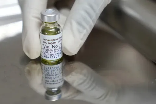 A pharmacist holds a vial of lenacapavir, the new HIV prevention injectable drug, at the Desmond Tutu Health Foundation's Masiphumelele Research Site, in Cape Town, South Africa, Tuesday, July 23, 2024, which was one of the sites for Gilead's lenacapavir drug trial. (AP Photo/Nardus Engelbrecht, File)