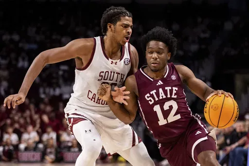 Mississippi State guard Josh Hubbard (12) drives on South Carolina forward Collin Murray-Boyles, left, during the first half of an NCAA college basketball game on Saturday, Jan. 25, 2025, in Columbia, S.C. (AP Photo/Scott Kinser)