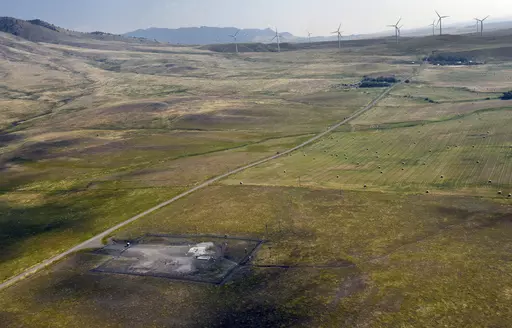 In this image provided by the U.S. Air Force, wind turbines spin near the Malmstrom Air Force Base missile launch site Alpha-03 in Geyser, Mont., in August 2023. As the nation's energy needs have increased, turbines have grown in size and number, and are being placed closer to the underground silos where Minuteman III intercontinental ballistic missiles are kept ready to fire. The Air Force is concerned that the turbines are making it dangerous for their helicopter crews to fly out to the sites,