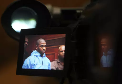 Thabo Bester is seen on a TV camera screen in the Western Cape High Court, in Cape Town, South Africa Thursday, May 3, 2012, where he appeared in connection with murder. The South African convicted murderer who faked his death to escape from prison has been arrested in Tanzania following a two-week manhunt, police have announced. South African officials are going to Tanzania Sunday April 9, 2023, to begin to extradite Thabo Bester. (AP Photo/Nardus Engelbrecht)