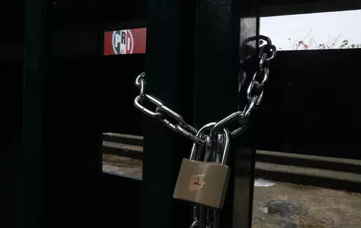 The doors of the headquarters of Mexico's Institutional Revolutionary Party, PRI, remain closed with chains in Mexico City, Wednesday, June 30, 2021. The PRI has been reduced to a shadow of its former self by the rise of President Andrés Manuel López Obrador's Morena party, which won the governorship of the last major PRI bastion, the State of Mexico, on June 2023. (AP Photo/Marco Ugarte, File)
