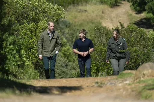 Britain's Prince William walks up Signal Hill with Park Manager for Table Mountain National Park Megan Taplin, right, and Australian conservationist and Earthshot Prize global ambassador Robert Irwin, left, in Cape Town, South Africa, Tuesday, Nov. 5, 2024. (AP Photo/Jerome Delay, Pool)