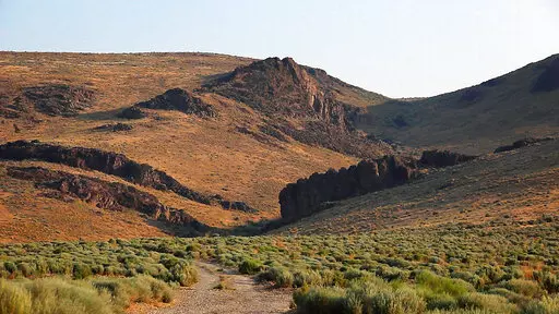 The Montana Mountains loom over Thacker Pass in northern Nevada on July 14, 2021. The new lithium mining project closest to development is the one proposed for Thacker Pass by Lithium Americas. That northern Nevada mine would make millions of tons of lithium available, but Native American tribes have argued that it's located on sacred lands and should be stopped. (Jason Bean/The Reno Gazette-Journal via AP, File)