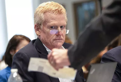Alex Murdaugh looks over evidence of a check brought to him and his attorneys during his double murder trial at the Colleton County Courthouse on Tuesday, Feb. 7, 2023, in Walterboro, S.C. The 54-year-old attorney is standing trial on two counts of murder in the shootings of his wife and son at their Colleton County home and hunting lodge on June 7, 2021. (Andrew J. Whitaker/The Post And Courier via AP, Pool)/The Post And Courier via AP, Pool)