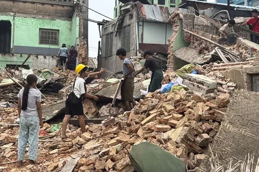 People clean debris from damaged buildings in the aftermath of an earthquake on March 28, in Naypyitaw, Myanmar, Monday, April 7, 2025. (AP Photo)