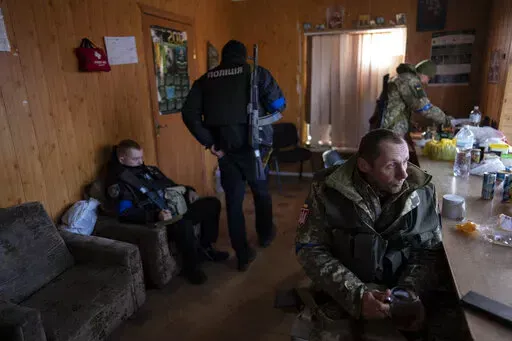 A soldier drinks tea during a break at a military check point, in Lityn, Ukraine, Wednesday, March 16, 2022. (AP Photo/Rodrigo Abd)