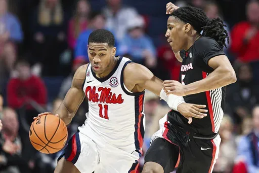 Mississippi guard Matthew Murrell (11) brings the ball up court against Georgia guard Silas Demary Jr. (5) during the first half of an NCAA college basketball game in Oxford, Miss., Saturday, Jan. 4, 2025. (AP Photo/Bruce Newman)