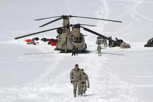 Capt. Corey Wheeler, front, commander of B Company, 1st Battalion, 52nd Aviation Regiment at Fort Wainwright, Alaska, walks away from a Chinook helicopter that landed on the glacier near Denali, April 24, 2016, on the Kahiltna Glacier in Alaska. The U.S. Army helped set up base camp on North America's tallest mountain. The U.S. Army is poised to revamp its forces in Alaska to better prepare for future cold-weather conflicts, and it is expected to replace the larger, heavily equipped Stryker Bri