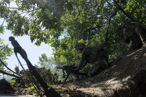 A Ukrainian marine of 35th brigade fires by automatic grenade launcher AGS-17 towards Russian positions on the outskirts of Avdiivka, Ukraine, on June 19, 2023. Ukrainian troops are under intense pressure from a determined Russian effort to storm the strategically important eastern Ukraine city of Avdiivka, officials say. Kyiv’s army is struggling with ammunition shortages as the Kremlin’s forces pursue a battlefield triumph around the two-year anniversary of Moscow’s full-scale invasion a