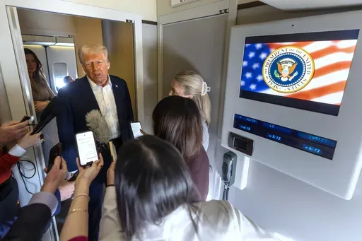 President Donald Trump speaks to reporters aboard Air Force One as he travels from Las Vegas to Miami on Saturday, Jan. 25, 2025. (AP Photo/Mark Schiefelbein)
