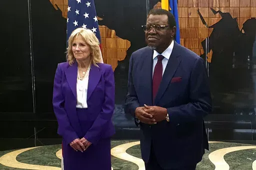U.S. First Lady Jill Biden, left, with Namibian President Hagers Geingob, right, at State House in Windhoek, Namibia Wednesday, Feb. 22, 2023. Biden is in the country as part of a commitment by President Joe Biden to deepen U.S. engagement with the region. (AP Photo/Dirk Heinrich)