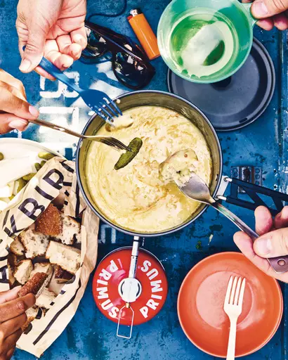 This image released by Clarkson Potter shows a recipe for caramalized shallot-cheese fondue from "Cook It Wild: Sensational Prep-Ahead Meals for Camping, Cabins, and the Great Outdoors" by Chris Nuttall-Smith. (Maya Visnyei /Clarkson Potter via AP)