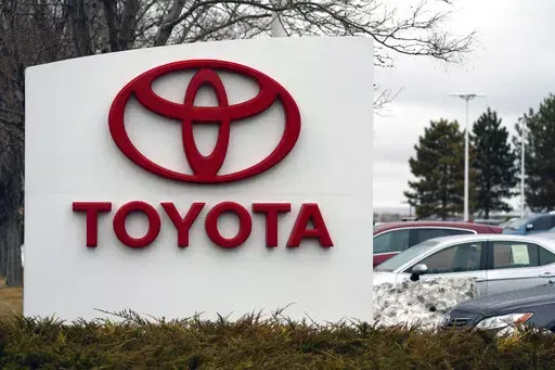 In this Sunday, March 21, 2021, photo, the company logo adorns a sign outside a Toyota dealership in Lakewood, Colo. Toyota customers soon won’t be able to get U.S. federal tax credits for buying electric or plug-in hybrid vehicles. Toyota's sales chief for North American, Bob Carter, said Wednesday, April 6, 2022, that the automaker expects to reach a 200,000-vehicle cap on the credits before the end of June. (AP Photo/David Zalubowski, File)