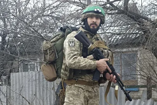 This 2023 photo provided by a 32-year-old professional soldier from Medellín, Colombia who goes by the call sign Checho shows him in his combat gear in Donbas, eastern Ukraine. Checho says he was struck by fire from a drone during a rescue operation to save a wounded colleague on the front line after three days of heavy fighting with Russian forces. At the hospital in the Kyiv region, Checho found himself with more than fifty other Colombians, most with light injuries sustained while fighting R