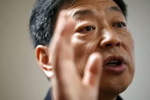 Wang Zhi'an speaks during an interview with the Associated Press in Tokyo on Oct. 5, 2022. Chinese investigative journalist Wang once exposed corruption, land seizures, and medical malpractice for state broadcaster CCTV. Today, he's in exile in Japan, and starting again as an independent journalist on YouTube. (AP Photo/Eugene Hoshiko)
