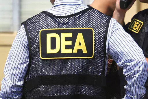 This June 13, 2016, file photo shows Drug Enforcement Administration agents in Florida.  A current U.S. Drug Enforcement Administration agent and a former supervisor in the agency were indicted Friday, May 20, 2022 on federal charges accusing them of leaking confidential law enforcement information to defense lawyers in Florida in exchange for cash and gifts. (Joe Burbank/Orlando Sentinel via AP)