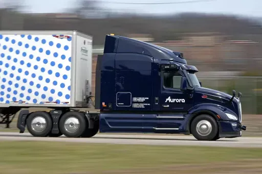 A self-driving tractor trailer maneuvers around a test track in Pittsburgh, Thursday, March 14, 2024. The truck is owned by Pittsburgh-based Aurora Innovation Inc. Late this year, Aurora plans to start hauling freight on Interstate 45 between the Dallas and Houston areas with 20 driverless trucks. (AP Photo/Gene J. Puskar)