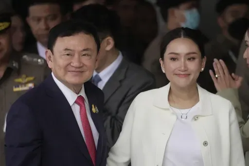 Thailand's former Prime Minister Thaksin Shinawatra, left, with, his daughter Paetongtarn, arrives at Don Muang airport in Bangkok, Thailand, Tuesday, Aug. 22, 2023.(AP Photo/Sakchai Lalit, File)