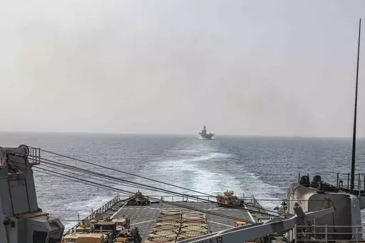 In this image provided by the U.S. Navy, the amphibious dock landing ship USS Carter Hall and amphibious assault ship USS Bataan transit the Bab al-Mandeb strait on Aug. 9, 2023. The top commander of U.S. naval forces in the Middle East says Yemen’s Houthi rebels are showing no signs of ending their “reckless” attacks on commercial ships in the Red Sea. But Vice Adm. Brad Cooper said in an Associated Press interview on Saturday that more nations are joining the international maritime missi