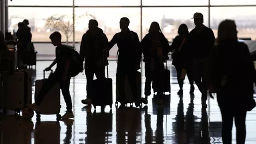 People pass through Salt Lake City International Airport Wednesday, Jan. 11, 2023, in Salt Lake City. Artificial intelligence chatbots like ChatGPT offer a novel way to research travel plans. They provide clear, easy-to-read suggestions that can be customized to almost any personal preference, leading to off-the-beaten-path suggestions that no guidebook or web search could provide. (AP Photo/Rick Bowmer, File)