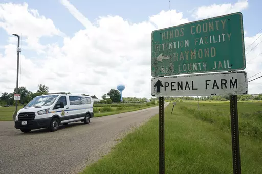 A Hinds County Sheriff's Department van passes the entrance to Hinds County Detention Facility, Aug. 1, 2022, in Raymond, Miss. Sheriff Tyree Jones said Monday, Oct. 16, 2023, that 200 inmates were removed from a part of the jail that has had security problems, and they were transferred to a privately run prison about two hours away. (AP Photo/Rogelio V. Solis, File)