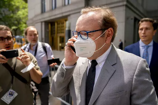 Kevin Spacey leaves court after testifying in a civil lawsuit, Thursday, May 26, 2022, in New York. British prosecutors have charged Spacey with four counts of sexual assault against three men. The 62-year-old double Academy Award winner was questioned by British police in 2019 about claims by several men that he had assaulted them. The U.K. charges were announced Thursday, as Spacey was testifying in a courtroom in New York City in a civil lawsuit. (AP Photo/John Minchillo)