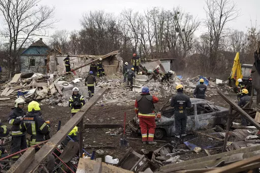 Emergency workers remove debris of a house destroyed following a Russian missile strike in Kyiv, Ukraine, Thursday, Dec. 29, 2022. (AP Photo/Roman Hrytsyna)