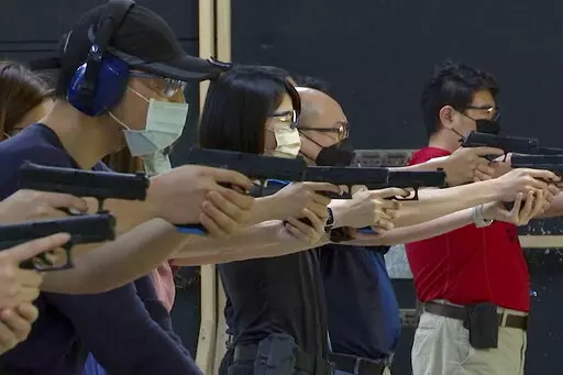 People shoot air soft guns at a private civilian training organization named Polar Light Training in New Taipei City, Taiwan on June 21, 2022. While an invasion doesn’t appear imminent, China's recent large-scale military exercises in response to a visit by U.S. House Speaker Nancy Pelosi to Taiwan have made the government in Taipei more aware than ever of the hard power behind Beijing’s rhetoric about bringing the self-ruled island under its control. Experts said that civilian defense and r