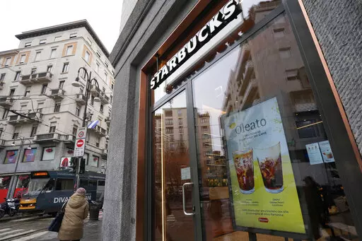 A Starbucks sign advertises the company's Oleato coffee in one of their coffee shops in Milan, Italy, Monday, Feb. 27, 2023. Putting olive oil in coffee is hardly a tradition in Italy, but that didn't stop Starbucks founder and CEO Howard Schultz from launching a series of beverages doing just that in Milan, the city that inspired his coffee house empire. (AP Photo/Antonio Calanni)