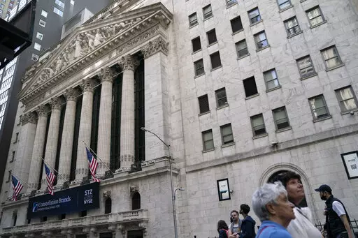 Pedestrians pass the New York Stock Exchange, Thursday, May 5, 2022, in the Manhattan borough of New York.  Stocks are opening lower and bond yields are rising as yet another report of robust hiring suggests the Federal Reserve will need to keep pressing the fight against inflation and cool off the economy with higher interest rates.  (AP Photo/John Minchillo)