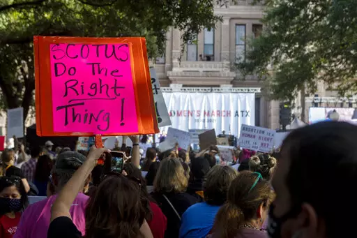 People attend the Women's March ATX rally, Oct., 2, 2021, at the Texas State Capitol in Austin, Texas. The Texas Supreme Court on Friday paved the way for the nation's toughest abortion law to remain in place in a ruling that again deflated clinics' hopes of stopping — or even pausing — the restrictions anytime soon. (AP Photo/Stephen Spillman, File)