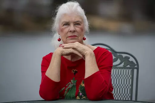 Wanda Olson poses for a photo, Friday, Dec. 17, 2021, in Villa Rica, Ga. When Olson’s son-in-law died in March after contracting COVID-19, she and her daughter had to grapple with more than just their sudden grief. They had to come up with money for a cremation. Even without a funeral, the bill came to nearly $2,000, a hefty sum that Olson initially covered. (AP Photo/Mike Stewart)