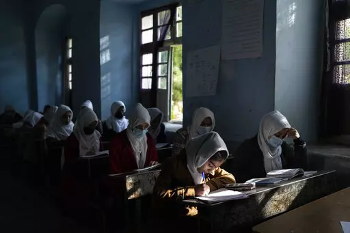 Afghan girls participate in a lesson at Tajrobawai Girls High School in Herat, Afghanistan on Nov. 25, 2021. In a surprise decision the hardline leadership of Afghanistan's new rulers has decided against opening educational institutions to girls beyond Grade six, a Taliban official said Wednesday, March 23, 2022 on the first day of Afghanistan's new school year. (AP Photo/Petros Giannakouris, File)