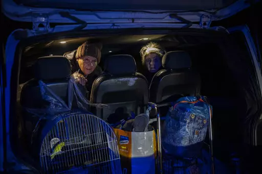 Elderly residents are evacuated by a local organization from the southern city of Kherson, Ukraine, Sunday, Nov. 27, 2022. Shelling by Russian forces struck several areas in eastern and southern Ukraine overnight as utility crews continued a scramble to restore power, water and heating following widespread strikes in recent weeks, officials said Sunday. (AP Photo/Bernat Armangue)