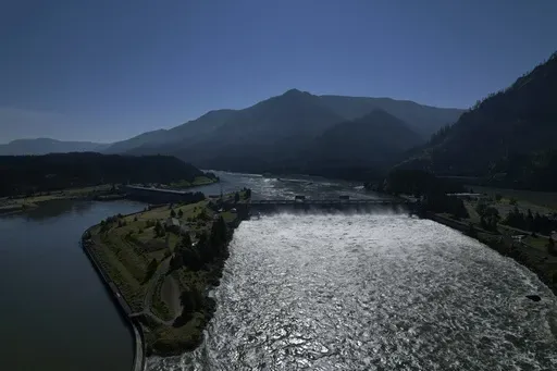 Water spills over the Bonneville Dam on the Columbia River, which runs along the Washington and Oregon state line, June 21, 2022. The U.S. and Canada said Thursday, July 11, 2024, that they have agreed to update a six-decade-old treaty that governs the use of one of North America’s largest rivers, the Columbia, with implications for electricity prices, irrigation, flood control and imperiled salmon runs. (AP Photo/Jessie Wardarski, File)