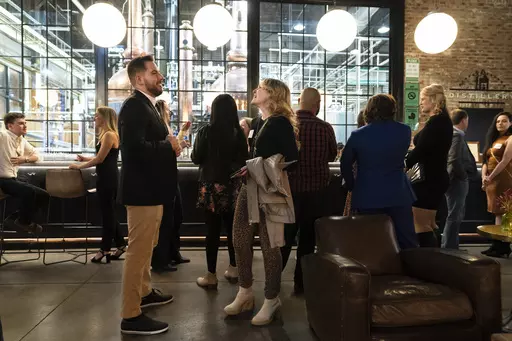 People mingle at a Philadelphia Distilling Daters Mixer Hosted by Date Him Philly, in Philadelphia, Tuesday, Nov. 14, 2023. Some of the most populous urban areas in the United States have an imbalanced sex ratio. Many of the largest counties along the Eastern Seaboard and in the Deep South skew female, while the largest urban counties in the West tilt male, according to data released this fall from the 2022 American Community Survey (AP Photo/Matt Rourke)