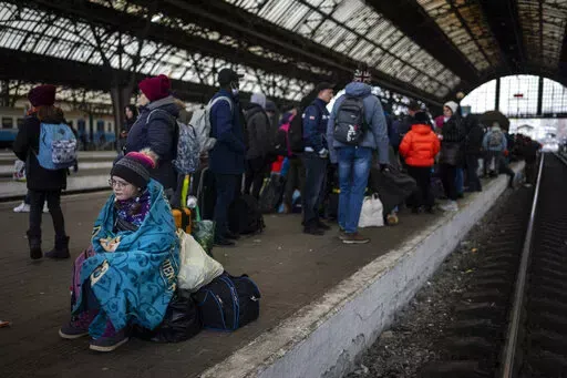 Passengers wait at the platform inside Lviv railway station, Sunday, Feb. 27, 2022, in Lviv, west Ukraine. (AP Photo/Bernat Armangue)