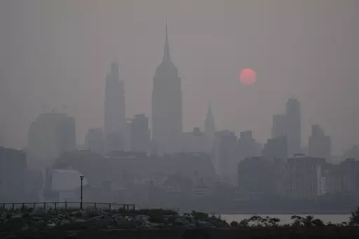 The sun rises over a hazy New York City skyline as seen from Jersey City, N.J., Wednesday, June 7, 2023. (AP Photo/Seth Wenig)