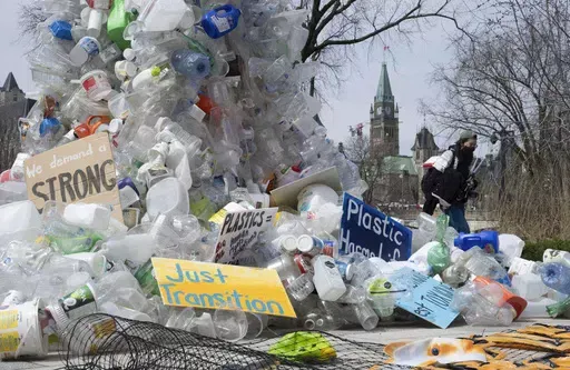A person walks past an art installation outside a United Nations conference on plastics on April 23, 2024, in Ottawa, Ontario. (Adrian Wyld/The Canadian Press via AP, File)