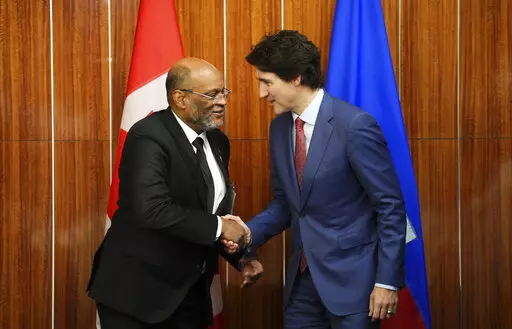 Prime Minister Justin Trudeau, right, takes part in a bilateral meeting with Prime Minister of Haiti Ariel Henry during the Conference of Heads of Government of the Caribbean Community (CARICOM) in Nassau, Bahamas, on Thursday, Feb. 16, 2023. (Sean Kilpatrick /The Canadian Press via AP)