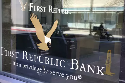 First Republic Bank signs and logos are attached to a window at a branch location, Wednesday, April 26, 2023, in Boston. Regulators seized troubled First Republic Bank early Monday and sold all of its deposits and most of its assets to JPMorgan Chase Bank in a bid to head off further banking turmoil in the U.S. (AP Photo/Steven Senne, File)
