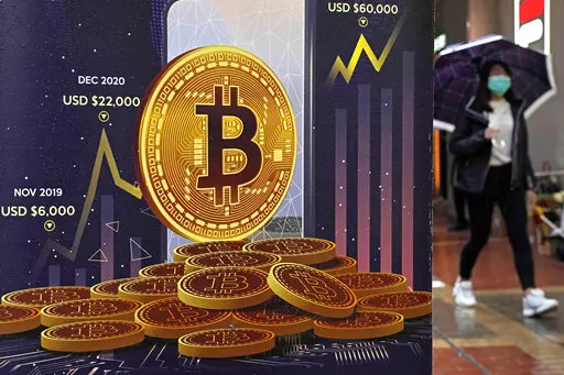 An advertisement for Bitcoin cryptocurrency is displayed on a street in Hong Kong on Feb. 17, 2022. Cryptocurrencies have experienced their worst plunge since 2018. As prices drop, companies collapse and skepticism soars, fortunes and jobs are disappearing overnight, and investors’ feverish speculation has been replaced by icy calculation, in what industry leaders are referring to as a “crypto winter.” (AP Photo/Kin Cheung, File)